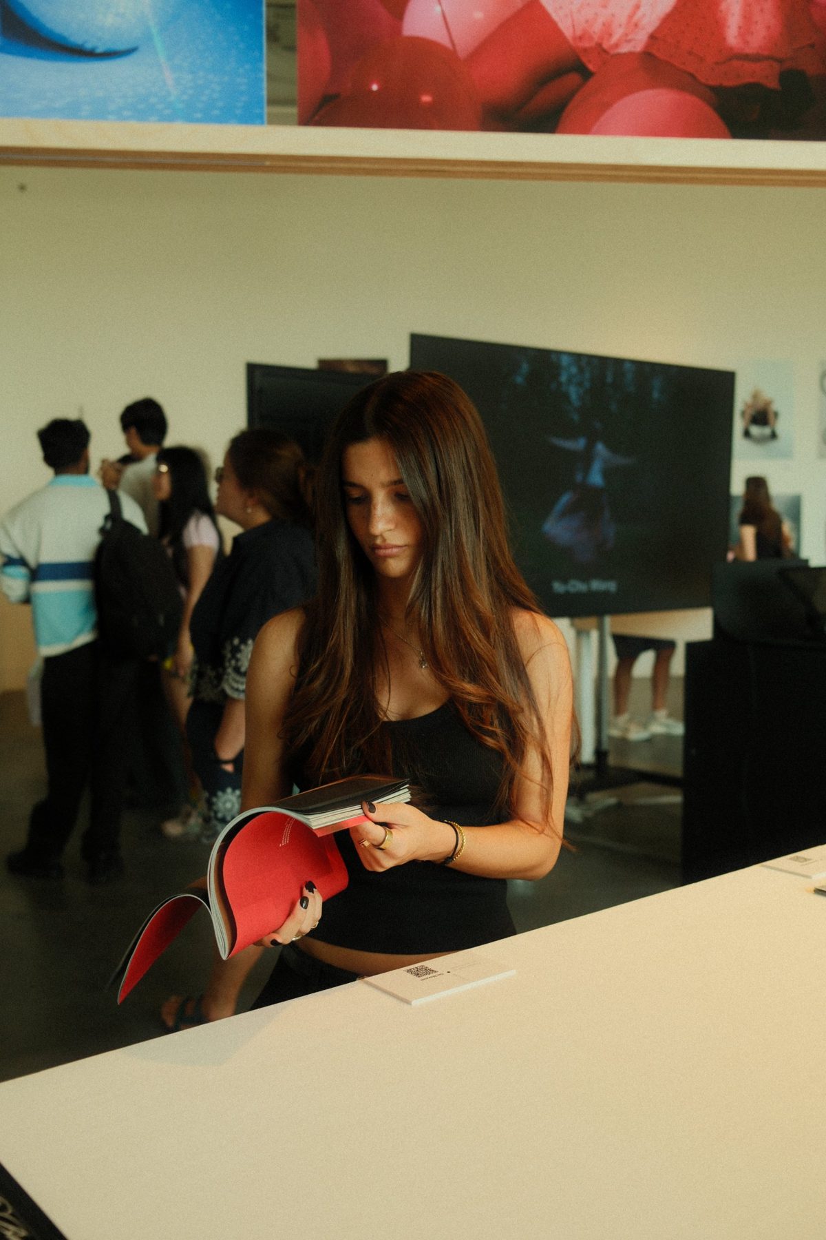 Gia reading through the zine at the exhibition