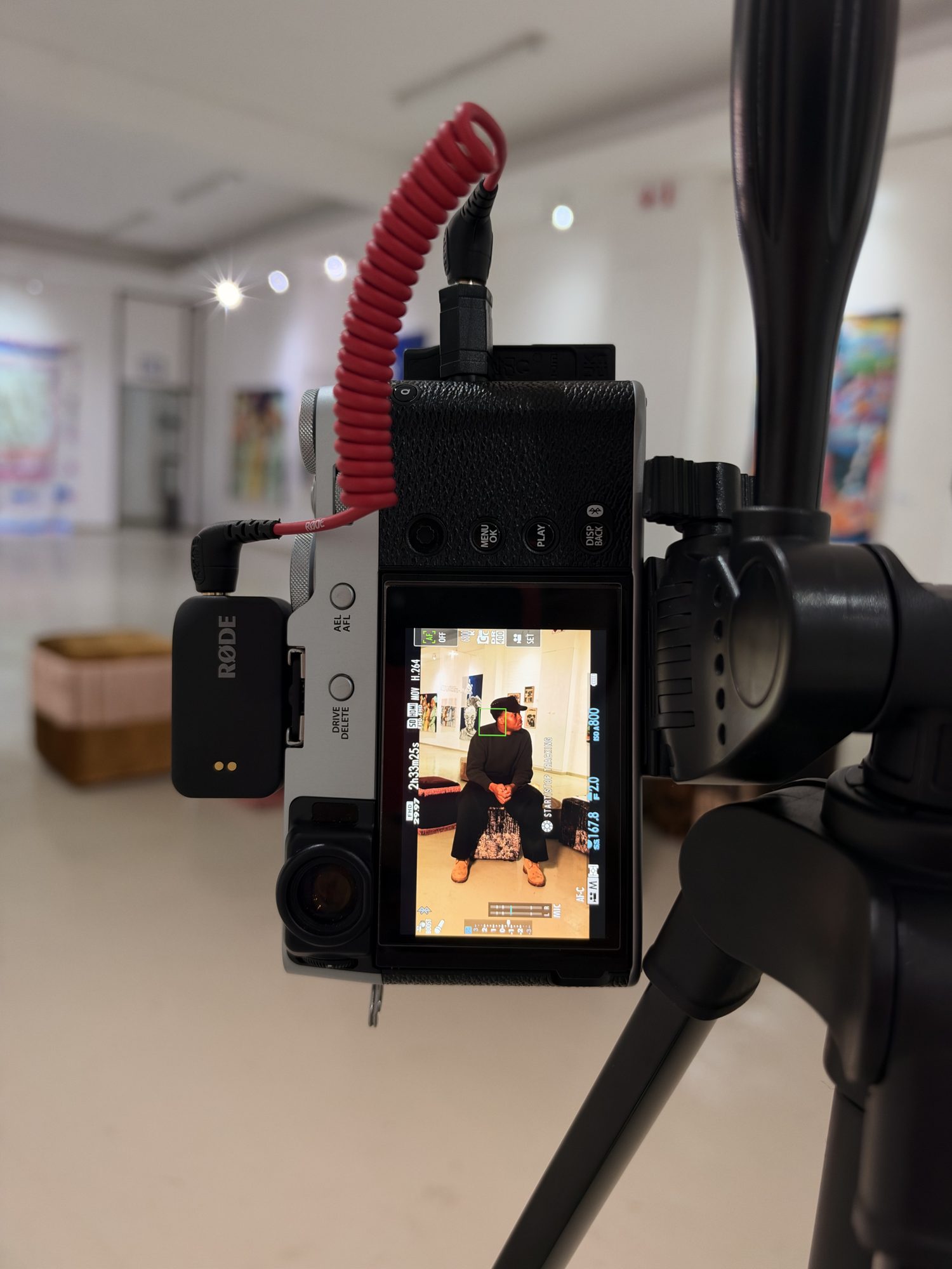 A camera on a tripod filming an interview